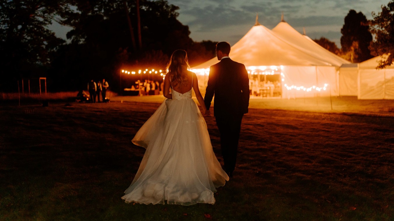 Bignor Park Weddings bride and groom Croquet Lawn reception in marquee at night