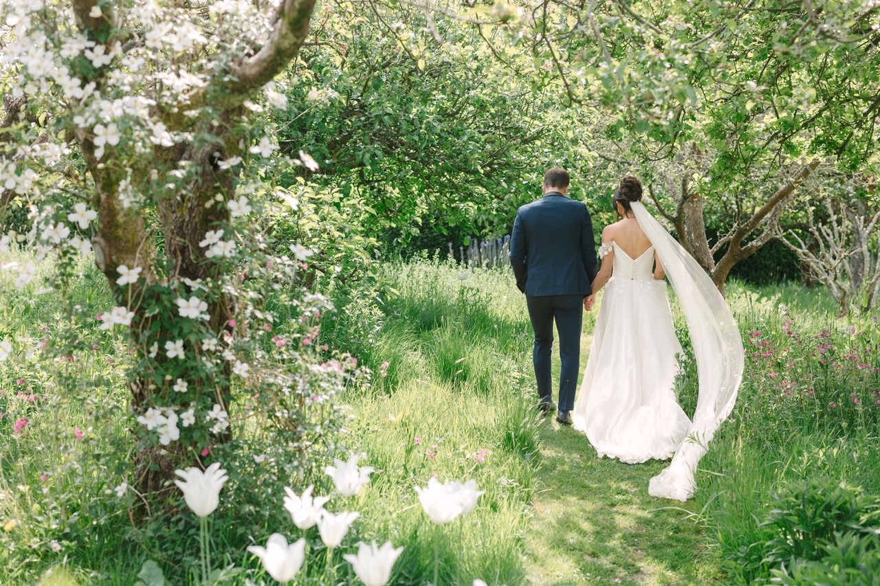 Bride and Groom strolling through Bignor Park grounds on their wedding day